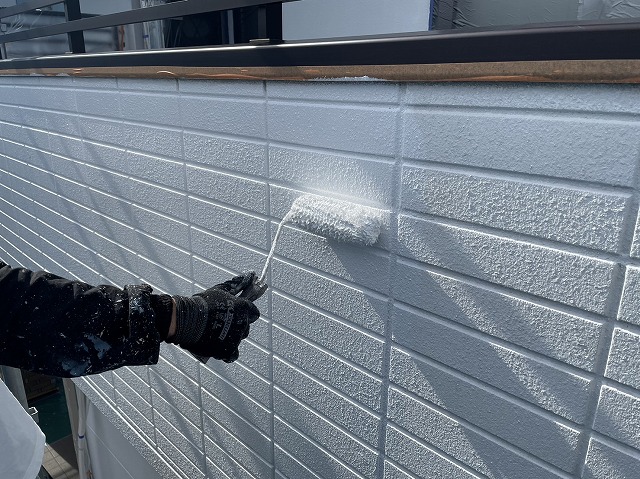 伊那市にて吹付塗装のALC外壁塗り替え工事、養生作業と異なる塗料で2回重ねた下塗り