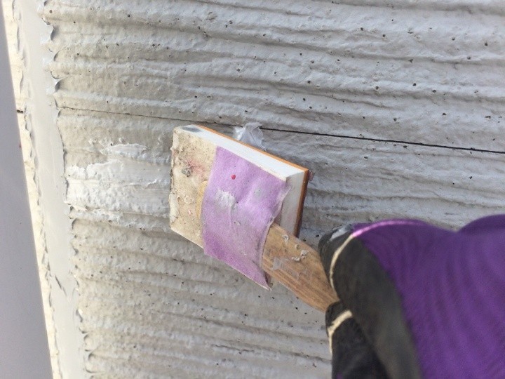 コーキング材の充填後にヘラで仕上げ作業