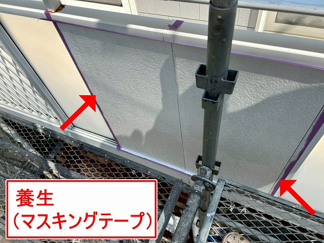 南アルプス市で黄ばみ・シミのある目隠しパネルに養生をかけて塗装する様子