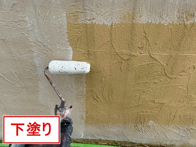 南アルプス市で目隠し擁壁に下塗り（白色）を行う様子