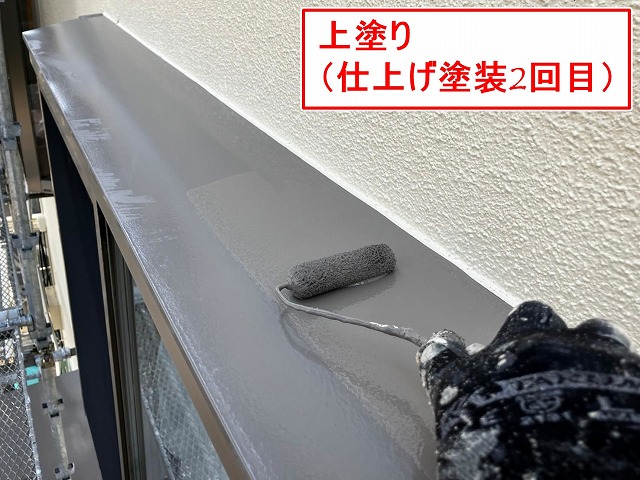 笛吹市で出窓上部(出窓板金)に上塗り(仕上げ塗装2回目)を行う様子